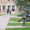 Man sitting on a bench on campus