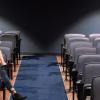 Two people sitting in an auditorium