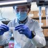 Qing Yang use the saliva test he developed in a lab