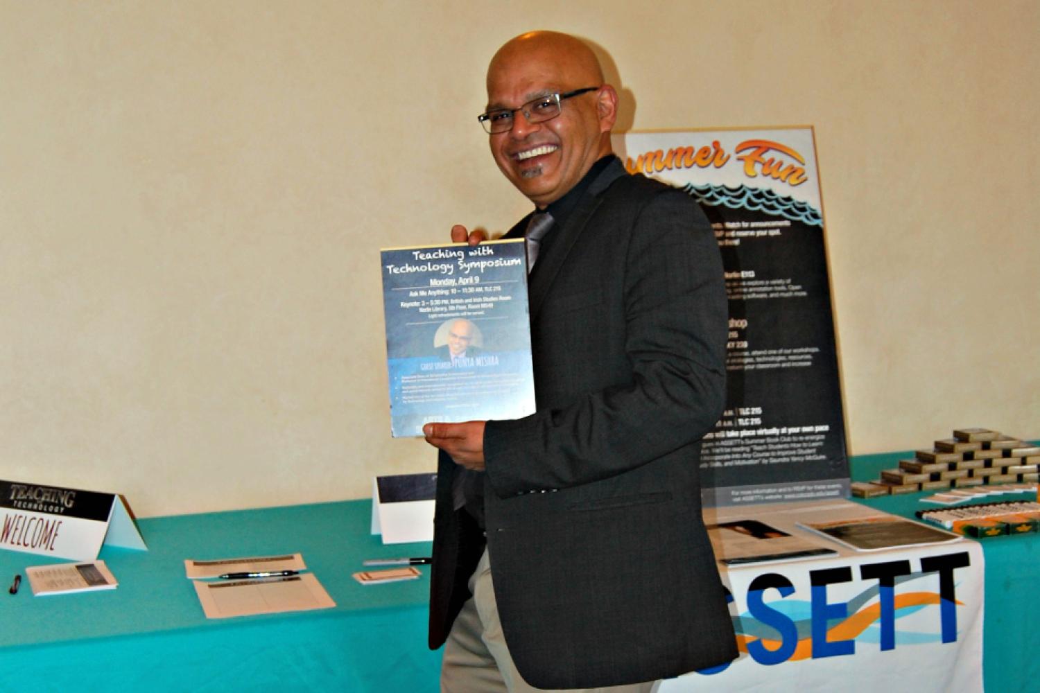 Punya Mishra poses with the flier announcing his keynote at the 2018 Teaching with Technology Symposium