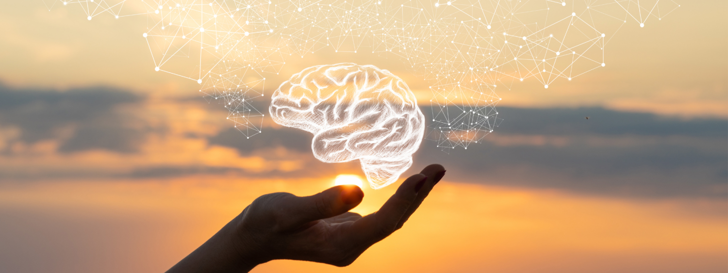 a hand holding a digital brain in the sunset