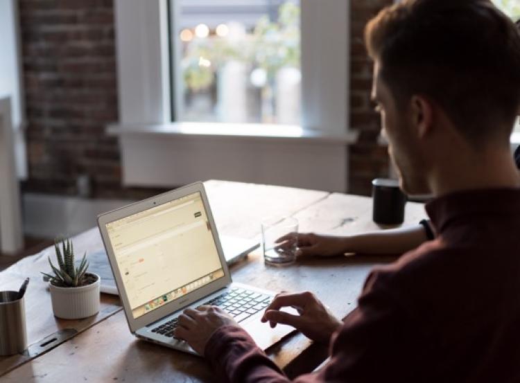 Man typing on a computer