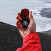 Hand holding a compass