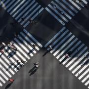 Pedestrians crossing two busy intersections.