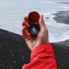Hand holding a compass