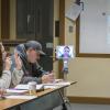 Students chatting with their instructor. One of the students appears on-screen on a Kubi device.