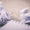 Blank notepad and crumpled papers