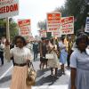 activists walking with signs