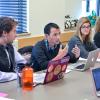 Students with laptops at a conference table