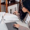 Student studying on laptop and with textbook