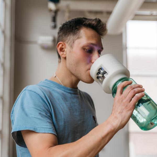 max kittay drinking from hydration monitoring and flavor altering water bottle