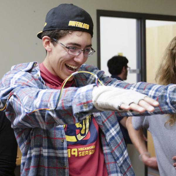 students playing with wearable tech on their arms
