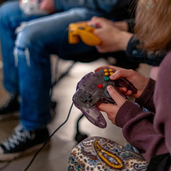 hands holding video game controllers