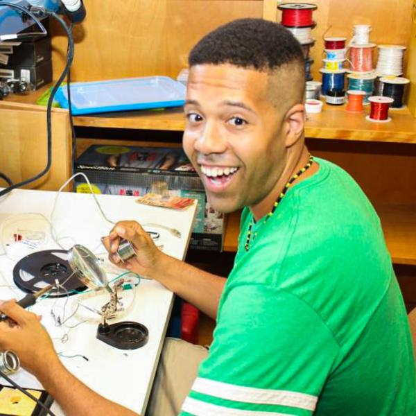 eric thompson holding a soldering gun