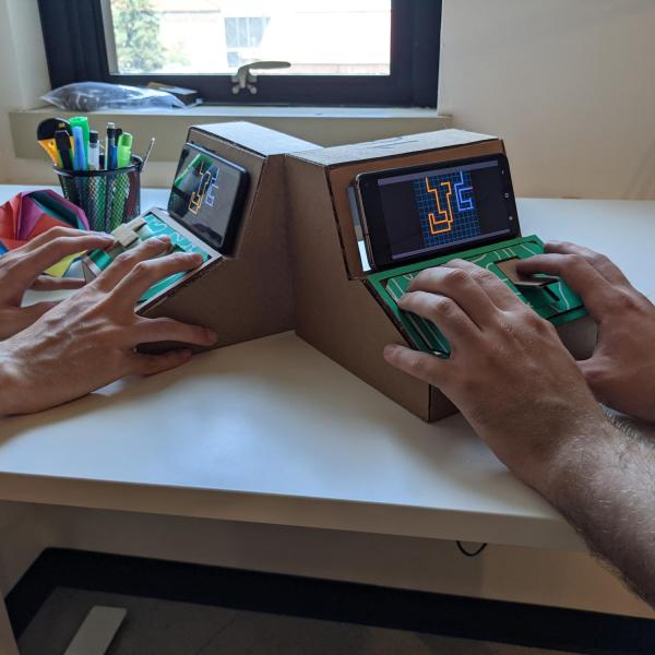 people playing on tinycade controllers