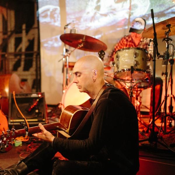 erikson surrounded by acoustic instruments