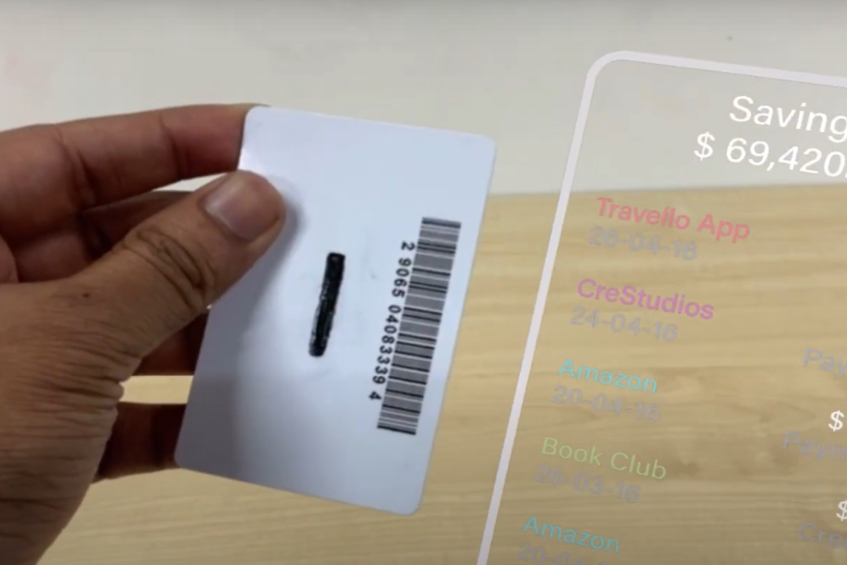 A person holding a card and showing the back. A digital overlay on the right side of the card shows savings and recent expenses.
