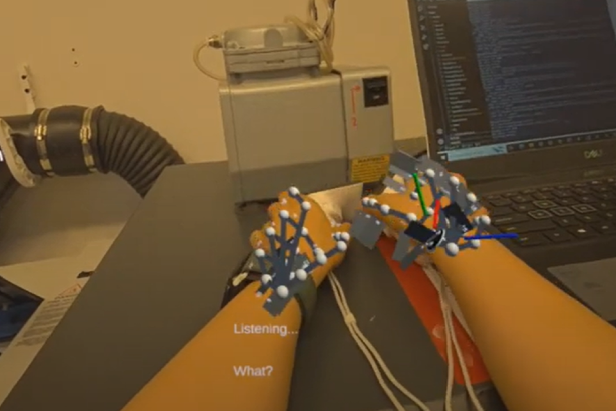 Hands holding a pair of hands holding two handheld VR remotes. A 3d model in the shape of a basic hand structure is overlaid with VR.