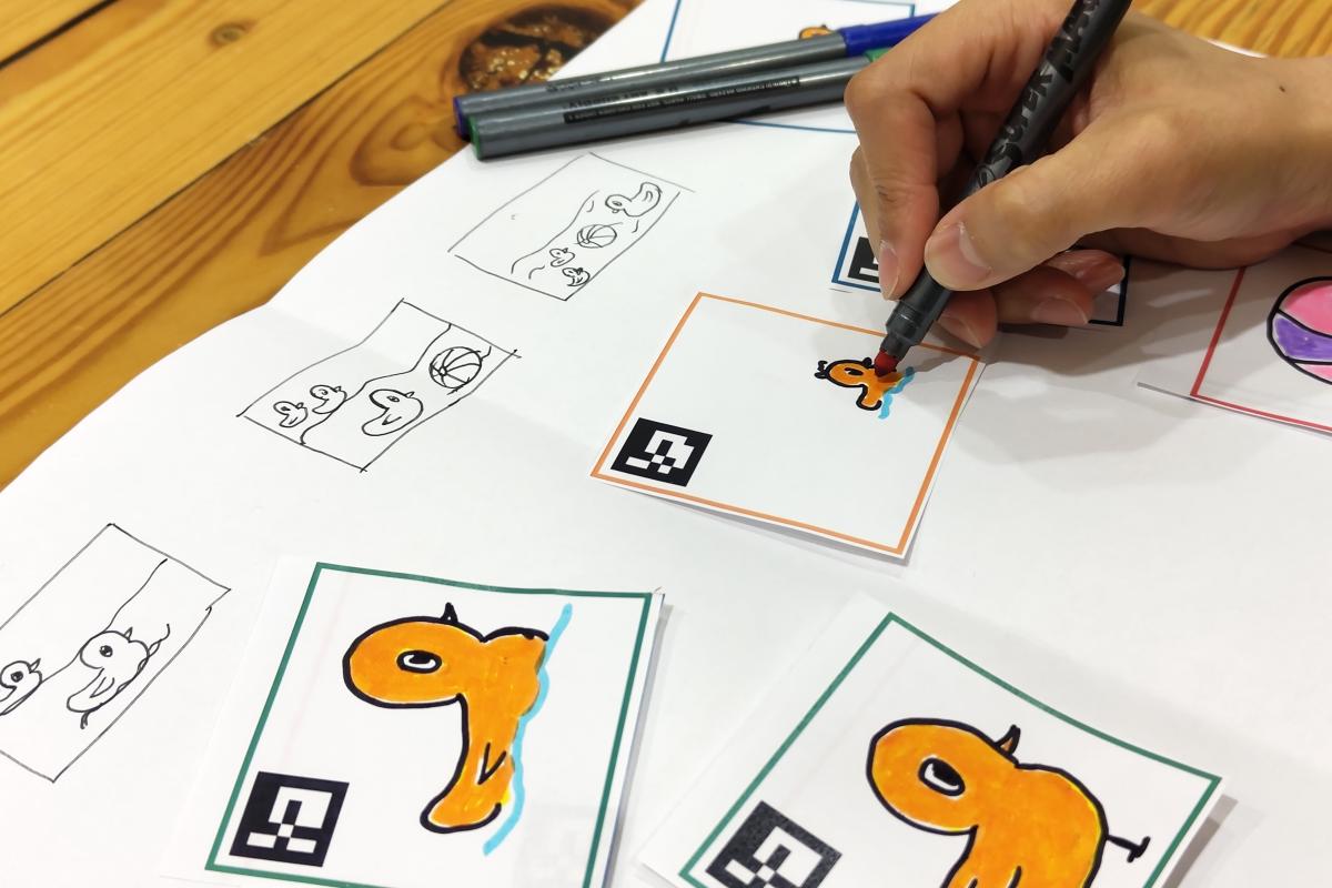 Person coloring cartoon drawings of ducks