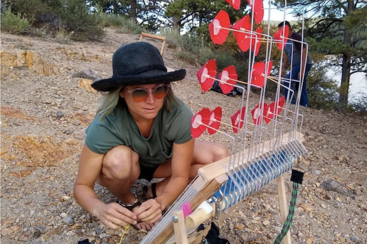 Person using wind loom outside