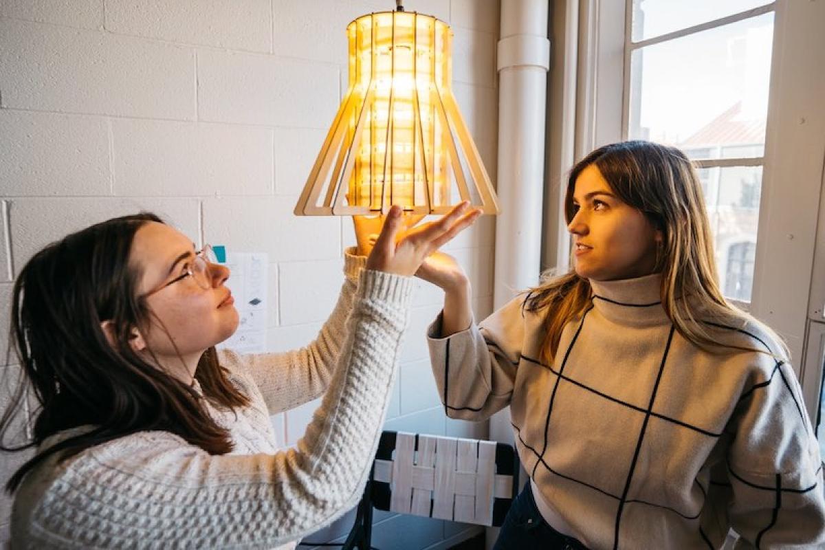 Students test a design for a hanging light
