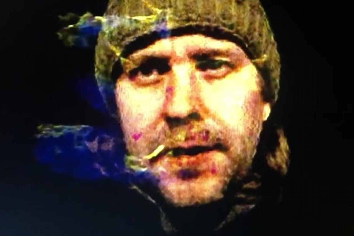 headshot of brad gallagher wearing a hat and surrounded by smoke