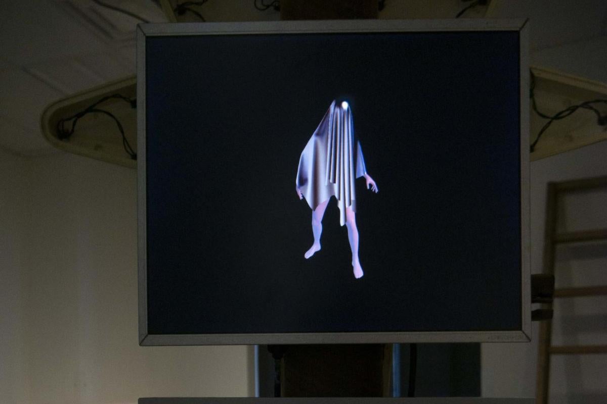 two screens aligned vertically, one with a shadowy figure