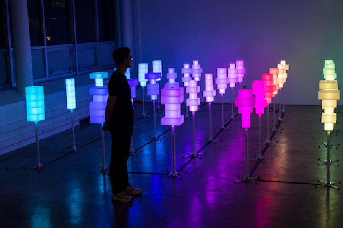 Field of 36 colored light towers in room.