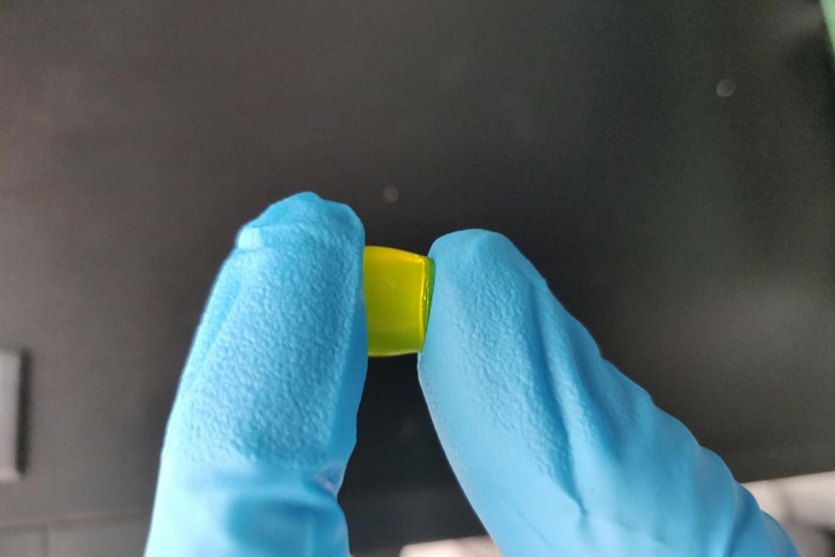 Two loved fingers holding slide ring gel.