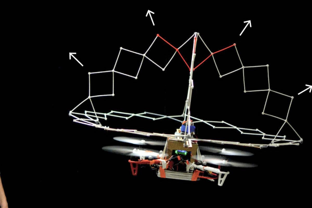 Ryo Suzuki looks at a nearby drone with expandable structure.