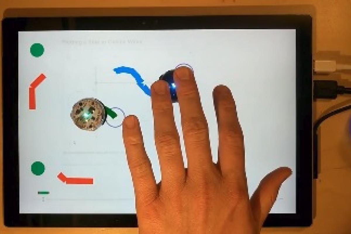 Demonstration of haptic video with small circular robots following a path created on screen by user.