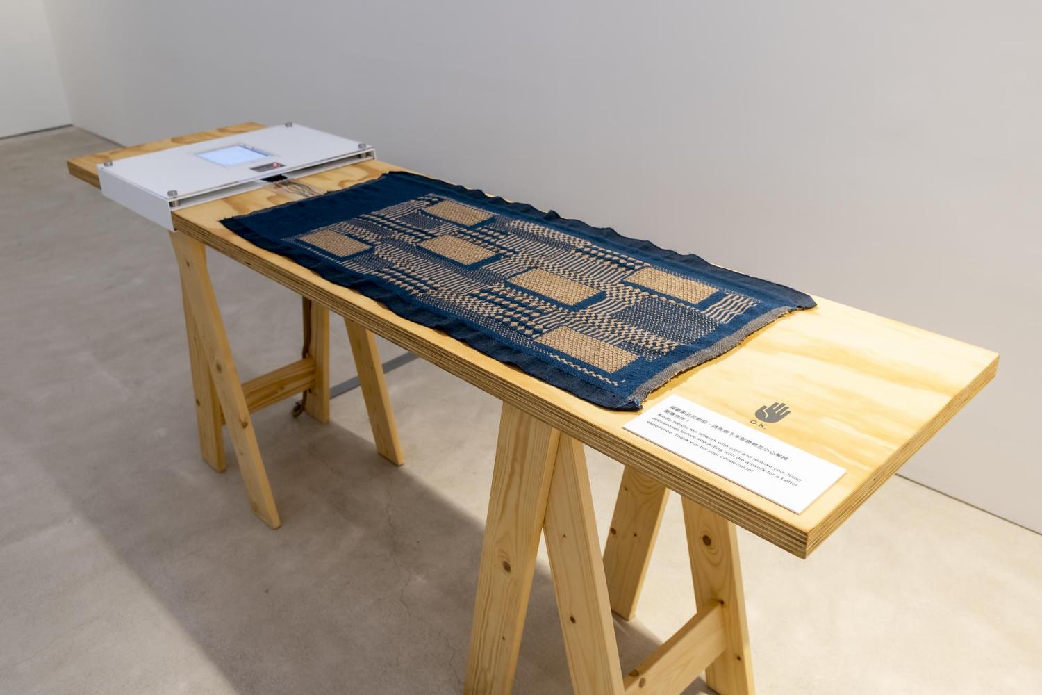 A Fabric that Remembers displayed on a table at the Centre for Heritage, Arts and Textile in Hong Kong 