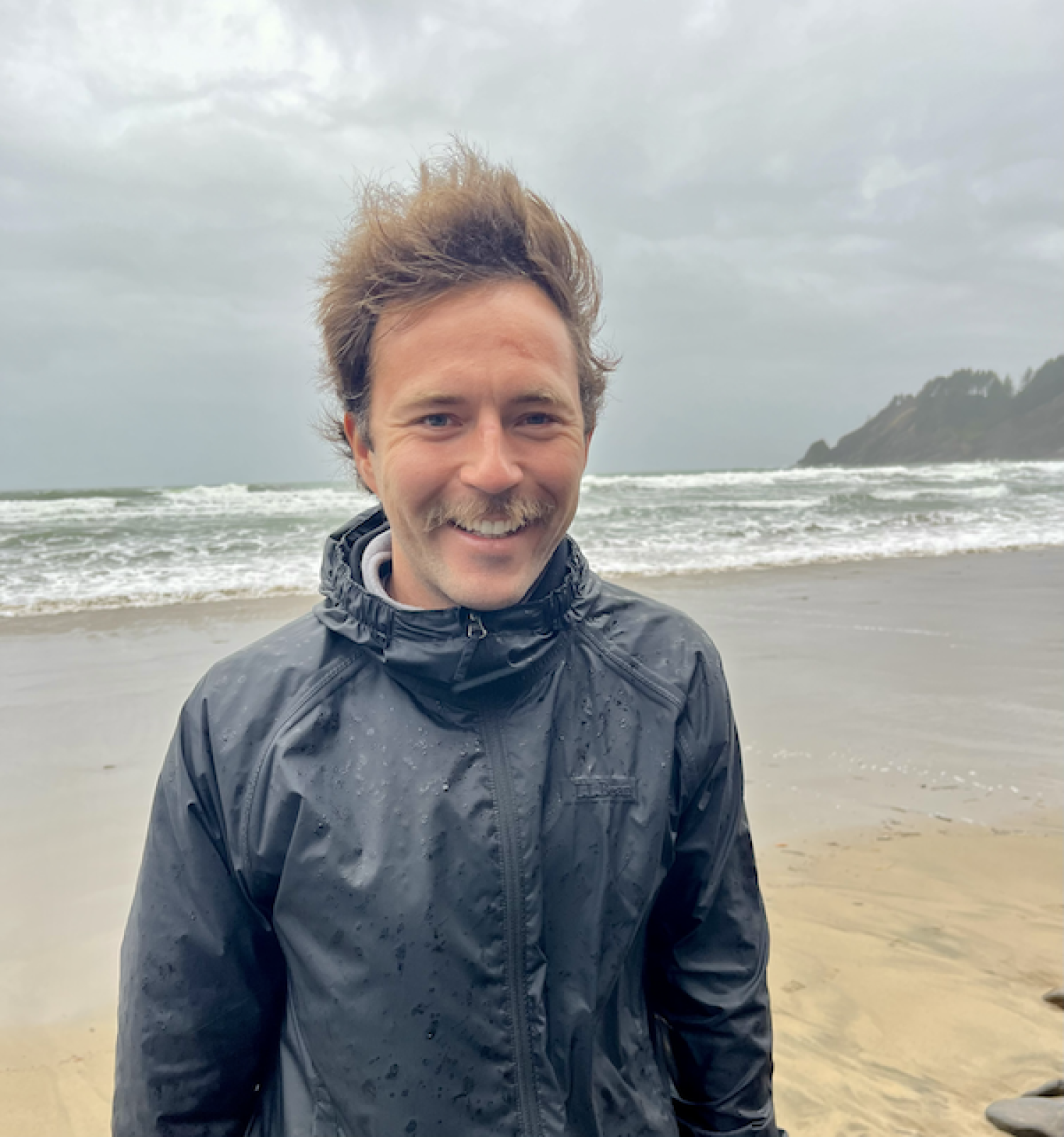 Brason Laszlo standing on a windy beach