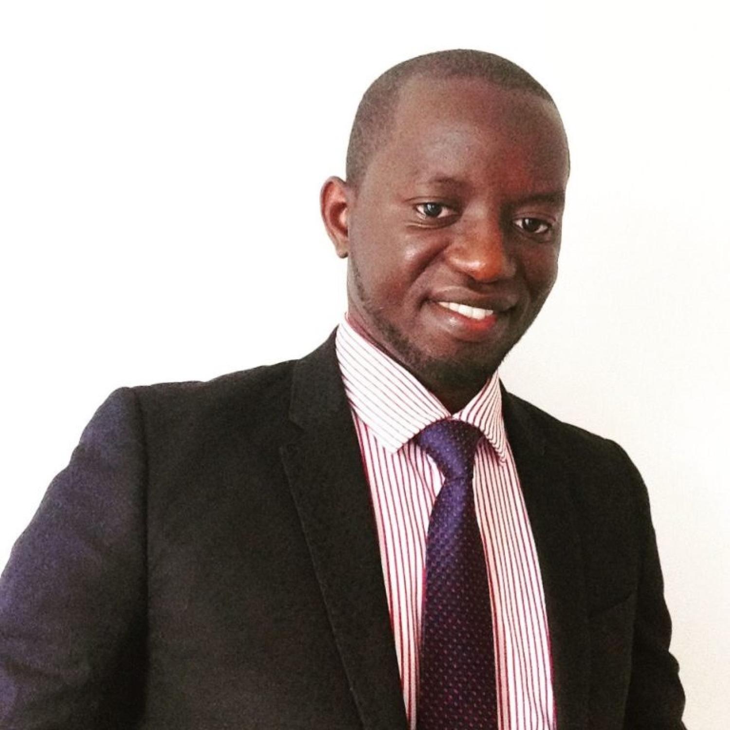 Victor wearing a suit standing against a white background