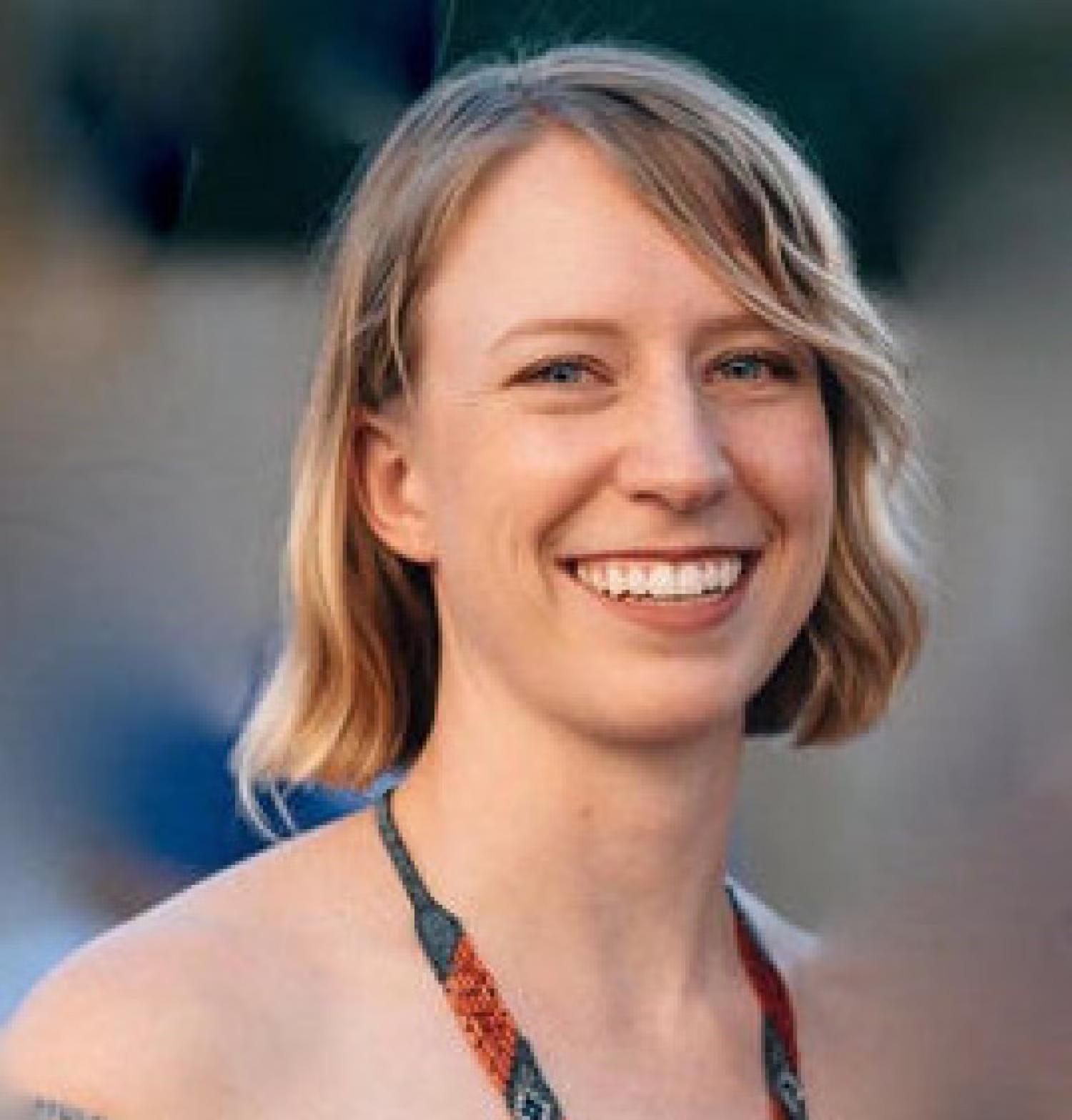Profile image of a young white woman with a wavy blonde bob, smiling.