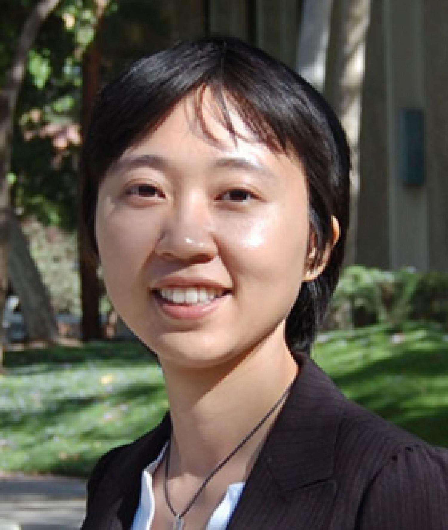 Profile image of an Asian woman with short black hair, smiling. She is wearing a black suit jacket.