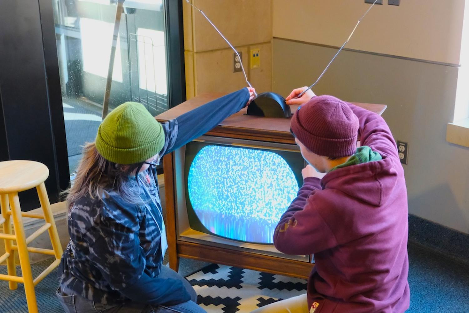 Whaaat Festival 2024 attendees play with an old TV