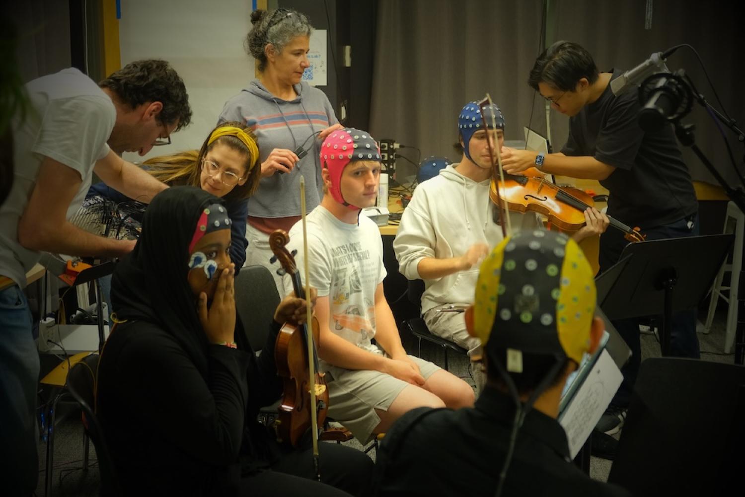 string quartet with EEG monitors and researchers around them