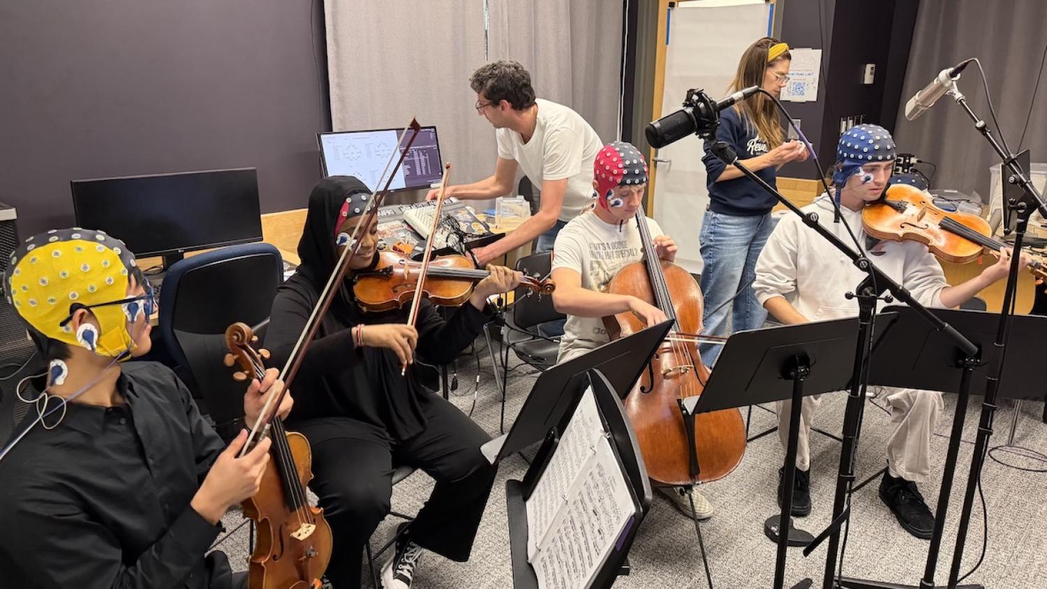 string quartet with EEG monitors and researchers around them