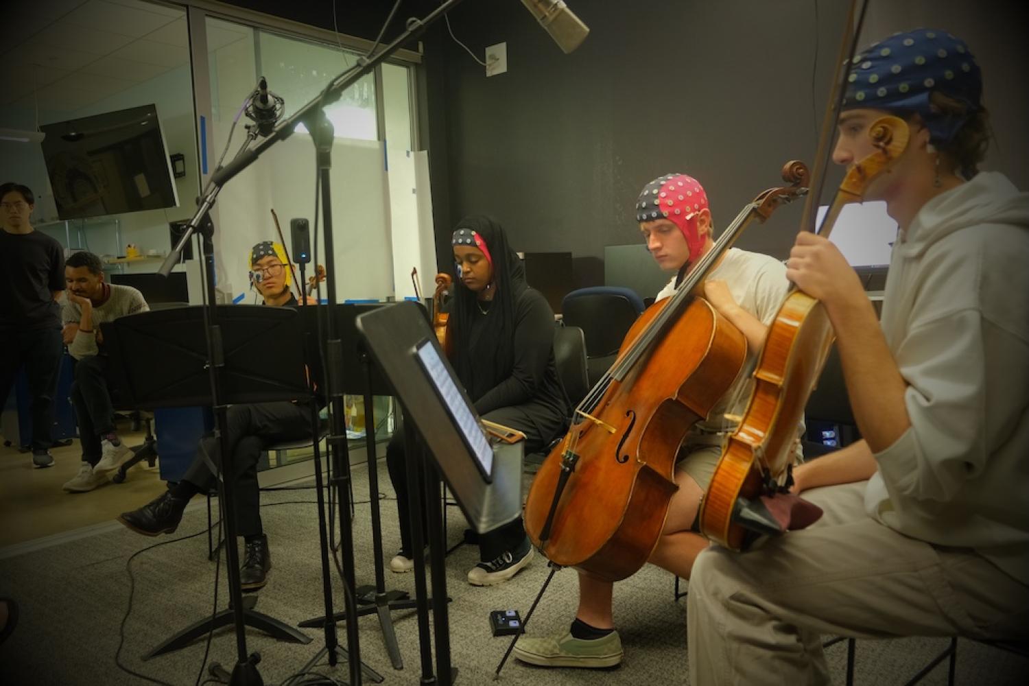 string quartet with EEG caps listens to music with their eyes closed