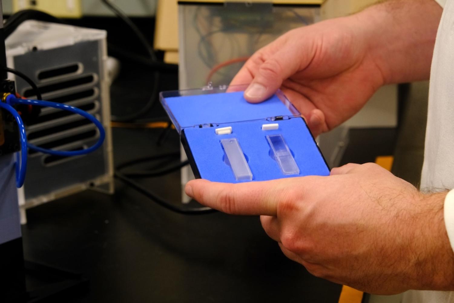 Living Matter Lab scientist holding small sample case