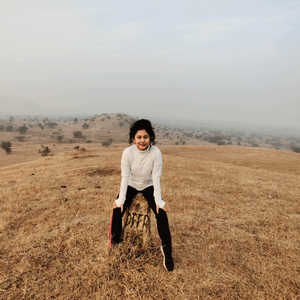Ishita Dey sits in front of foggy mountains