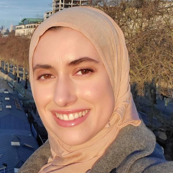 Latifa Al-Naimi in a headscarf in front of water.