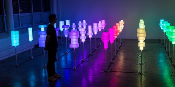 Field of 36 colored light towers in room.