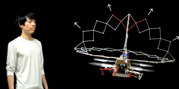 Ryo Suzuki looks at a nearby drone with expandable structure.