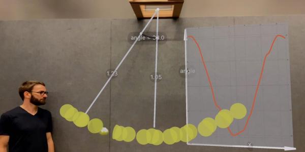 Using RealitySketch on an iPad to visualize the motion of a pendulum with a stroboscopic effect.