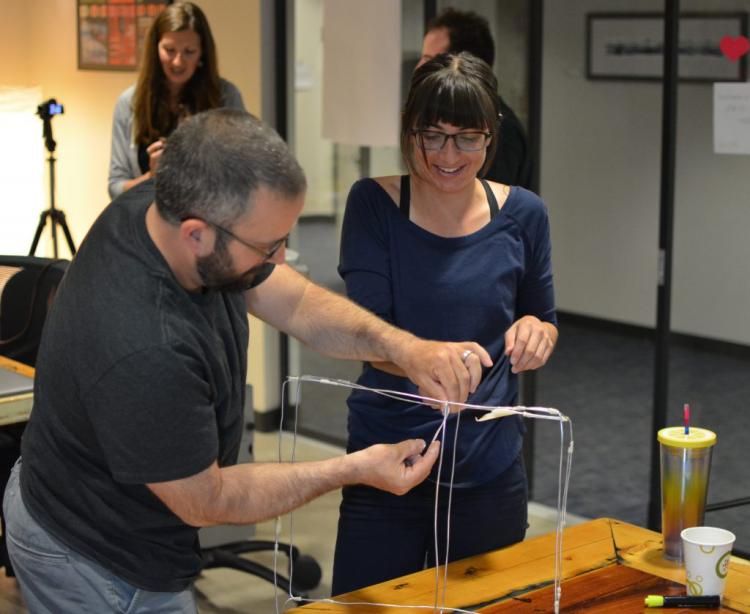 Teachers building a wire sculpture