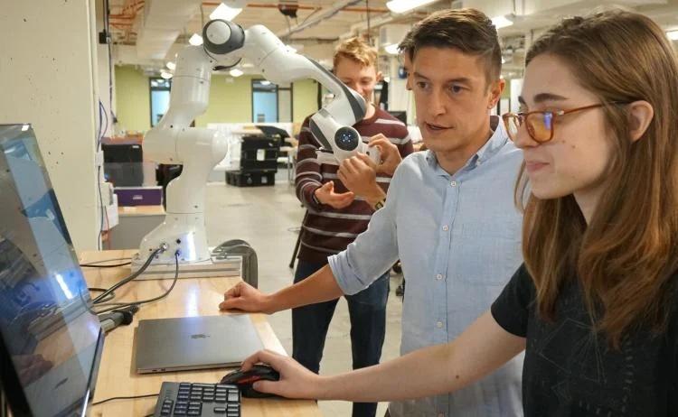 alessandro roncone working with student in robotics lab