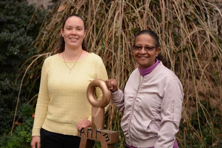 Donna August and Sandy Pitzak, chief advisor of the CU Boulder chapter of Tau Beta Pi chapter stand by the Bent of Tau Beta Pi, at the entrance to CU Boulder's engineering building.