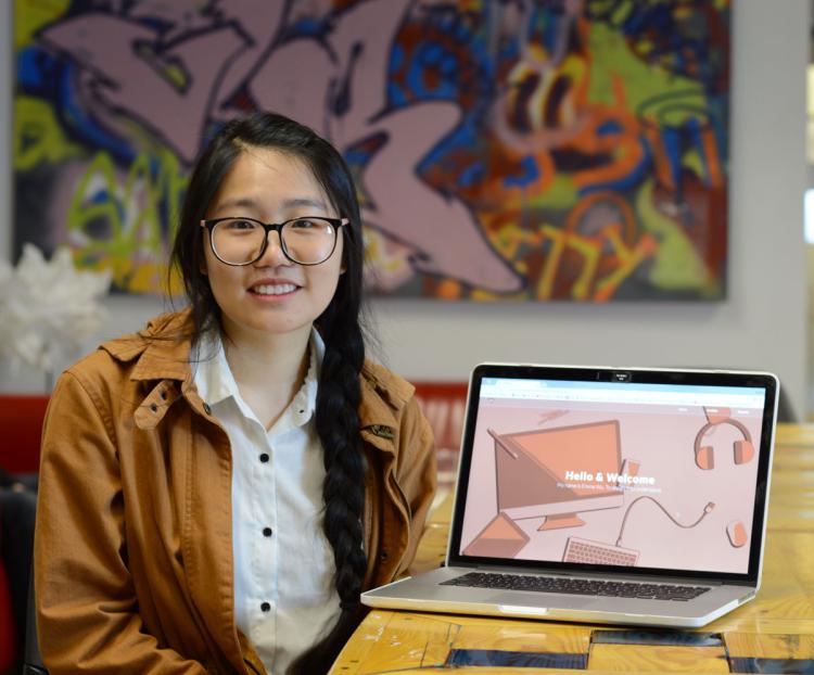 Emma Wu displays a website she designed and coded.